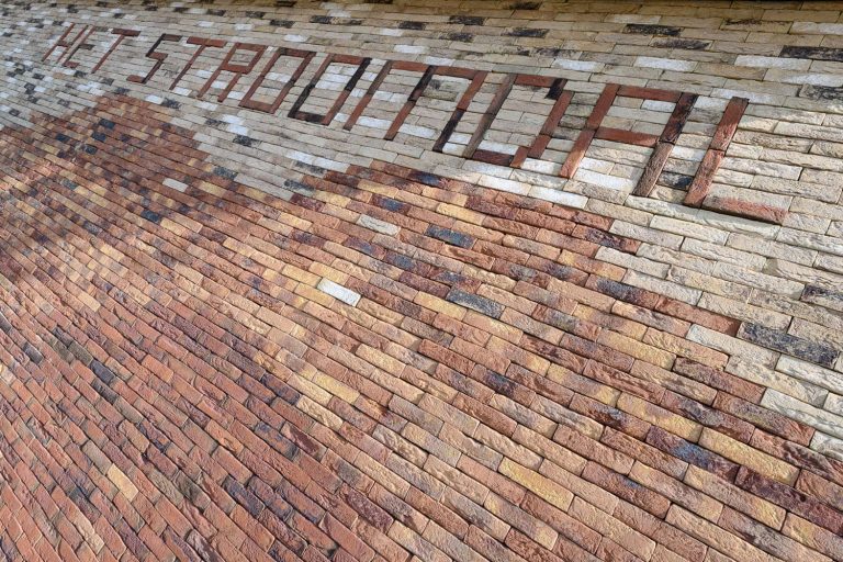 Stroomdal-Zuidlaren-Aberson-steenstrips-detail-met-golf-en-letters-gevel