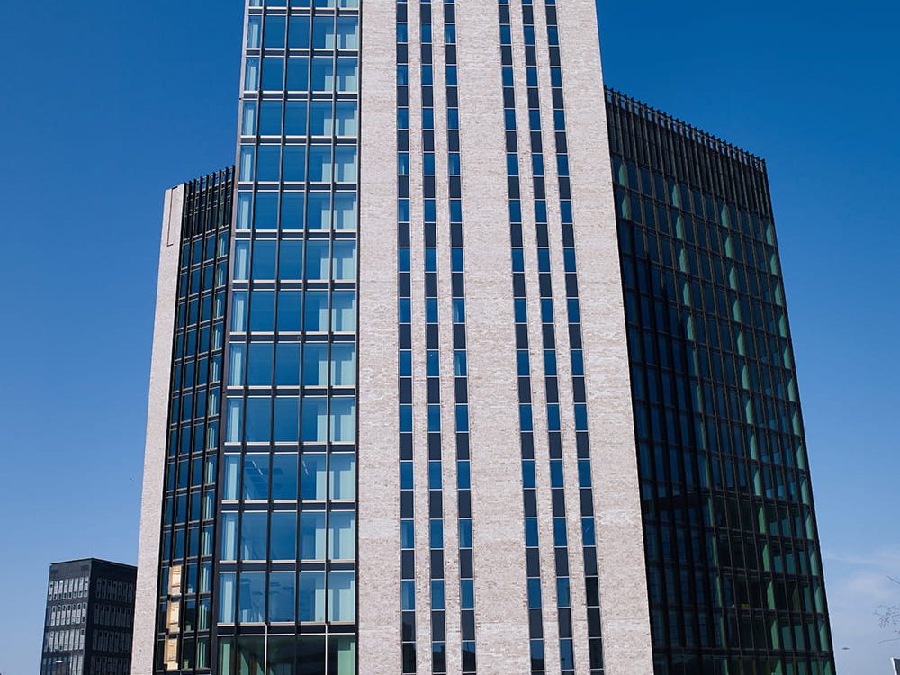 Sharing Tower in Amsterdam, hoog gebouw met ClickBrick en ramen tegen een blauwe lucht